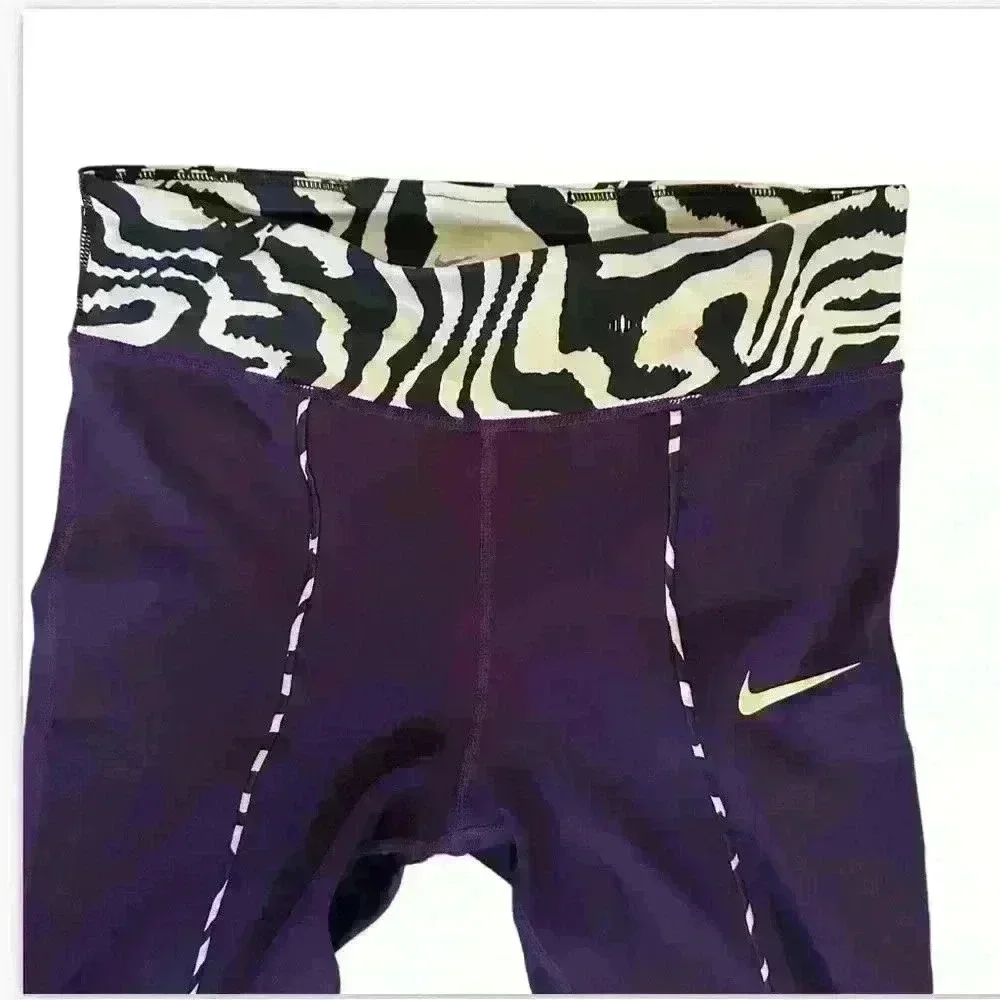 Nike Active pants size L in purple and green.